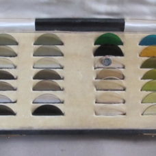 A Set of Circular Coloured Glass Samples for Spectacle Manufacture