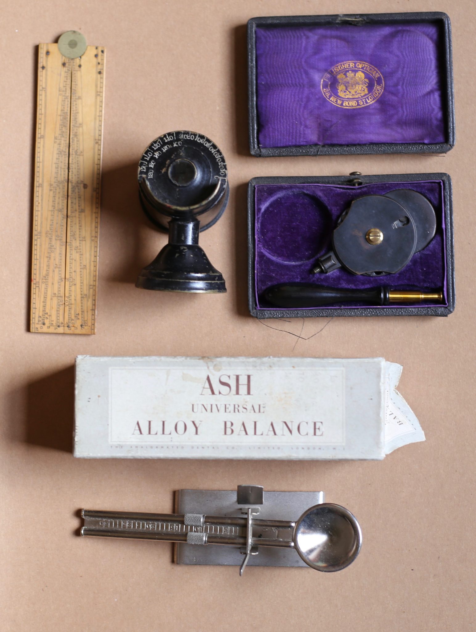 A Boxwood Sector, an Ash Universal Alloy Balance, a Model Eye and a Nettleship type Ophthalmoscope by Pillischer