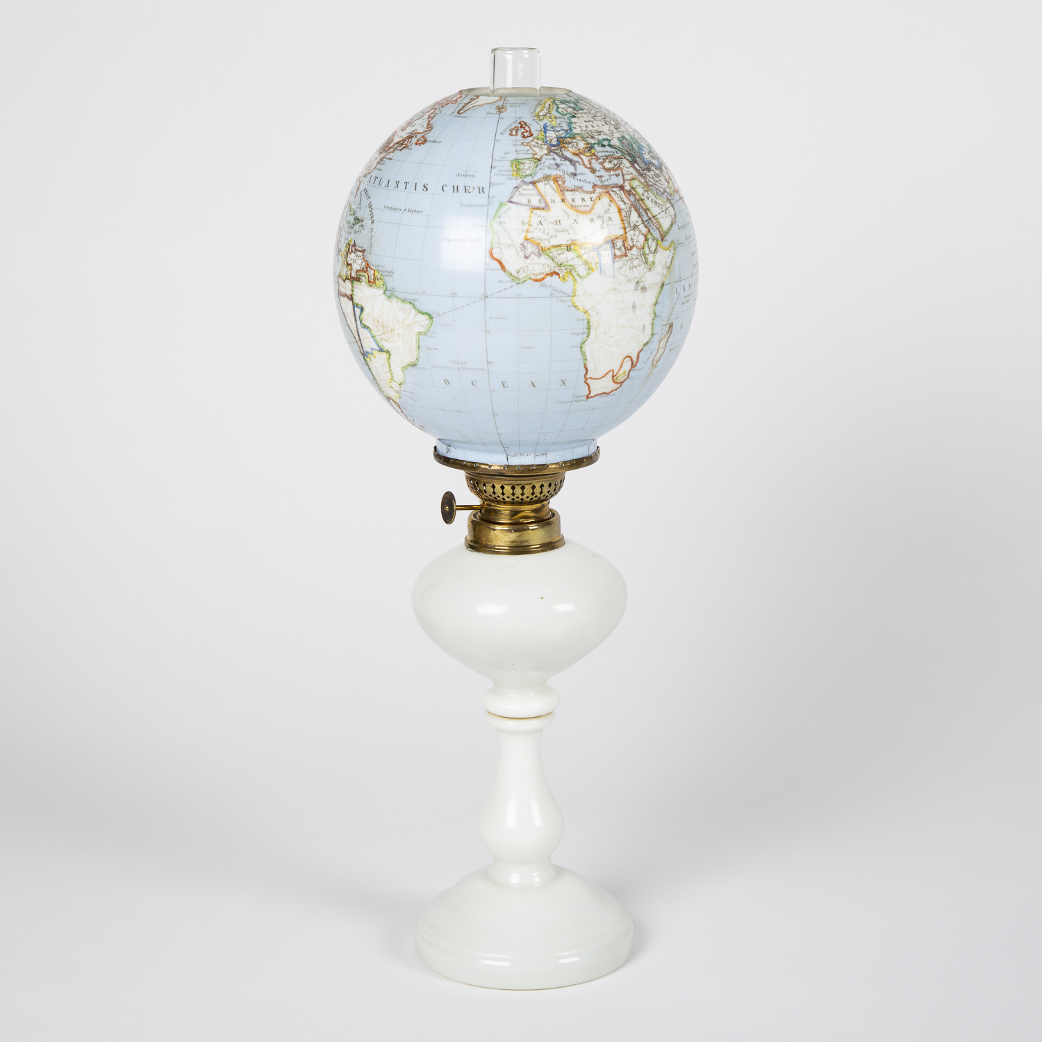 Oil lamp with an illuminating globe shade, Bohemia, circa 1885.