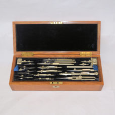 Antique cased drawing instruments in medium oak case.