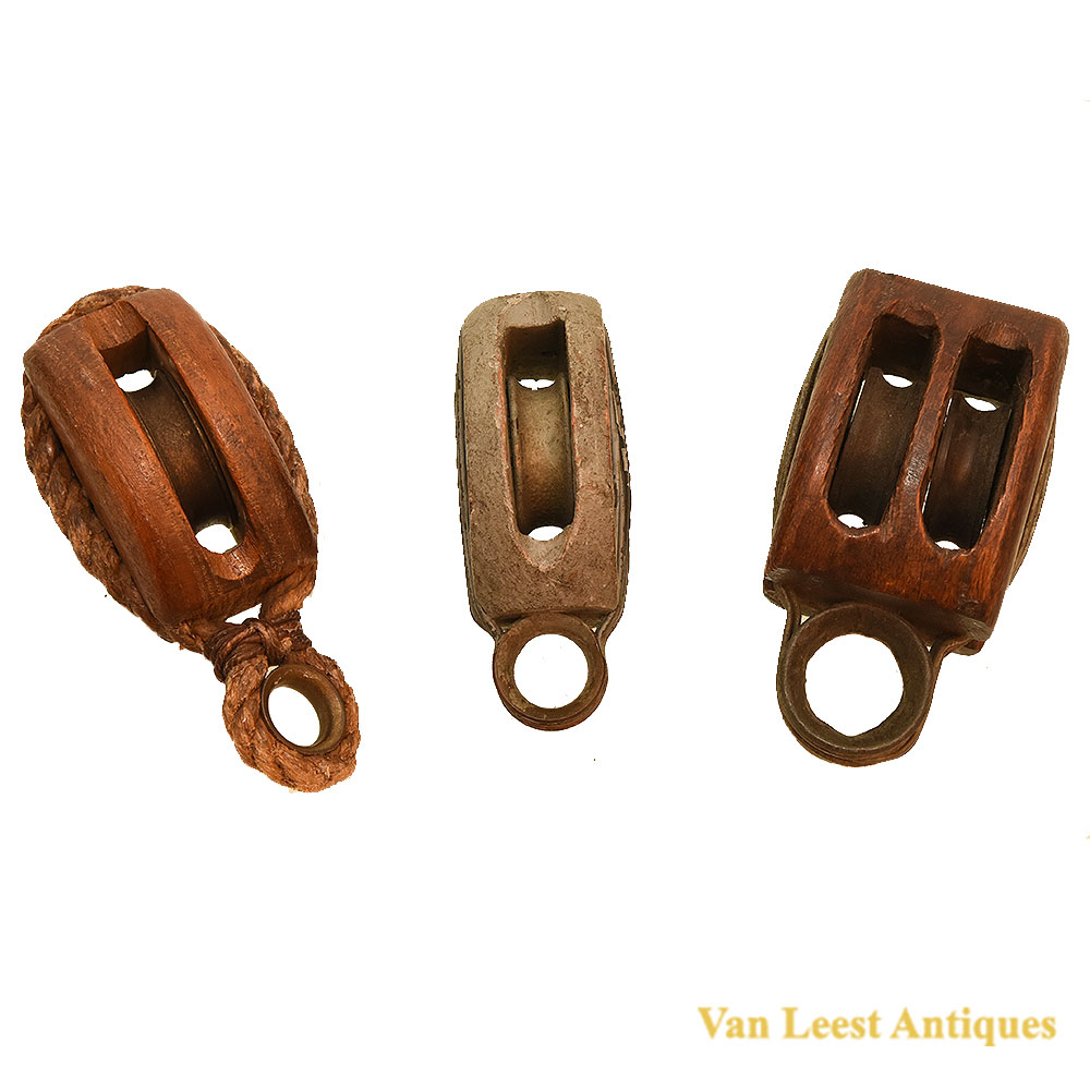 Three antique pulleys