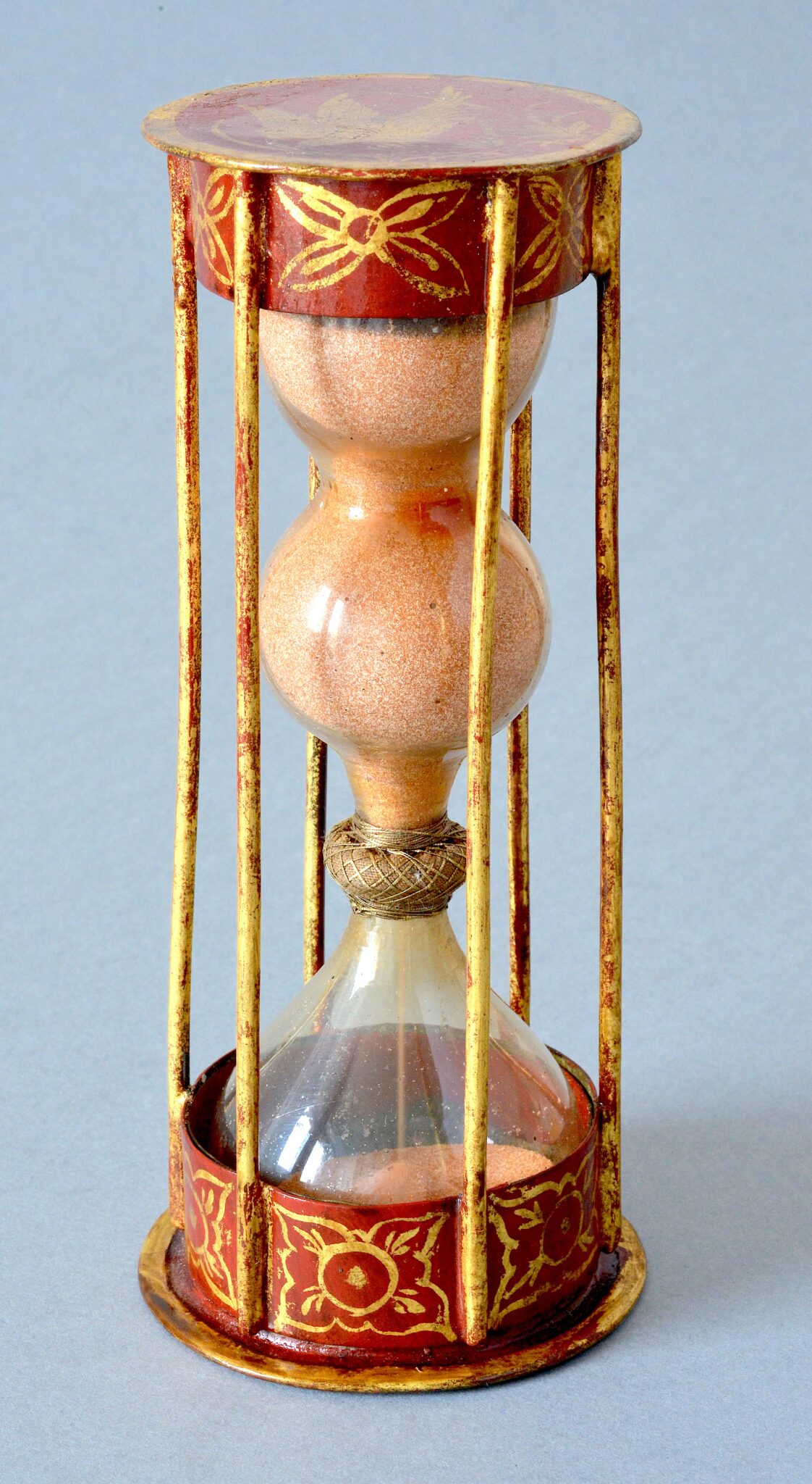 Hourglass in a red and gold painted metal frame made in France circa 1720/1730