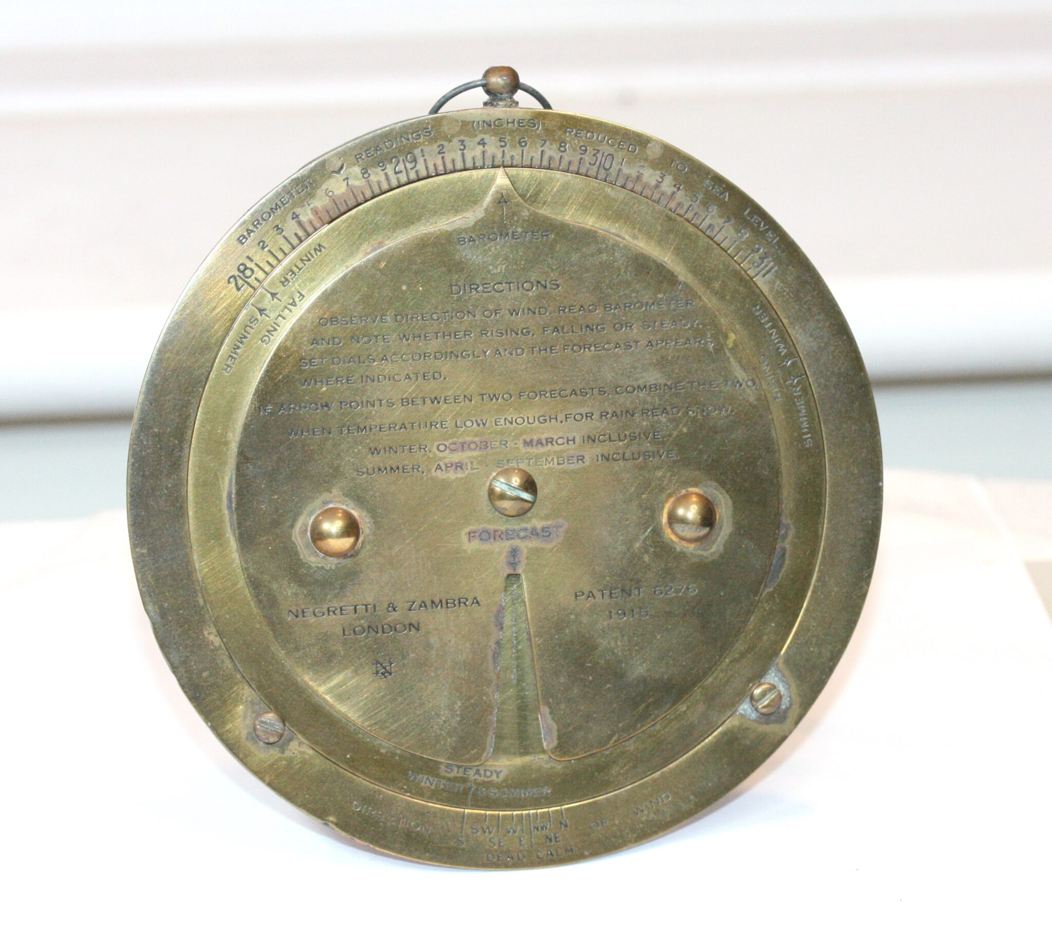 NEGRETTI & ZAMBRA  BRASS DESK STANDING  WEATHER FORECAST BAROMETER DATED 1915 WITH ITS CASE