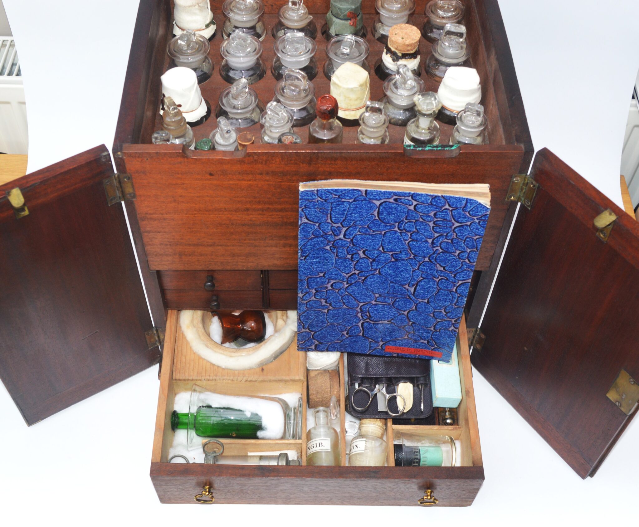 A large apothecary cabinet and contents.
