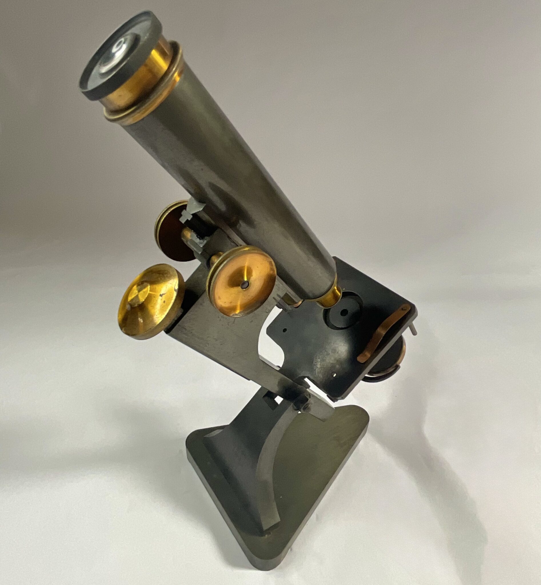 Antique microscope with case, slides and accessory lenses, 1890.