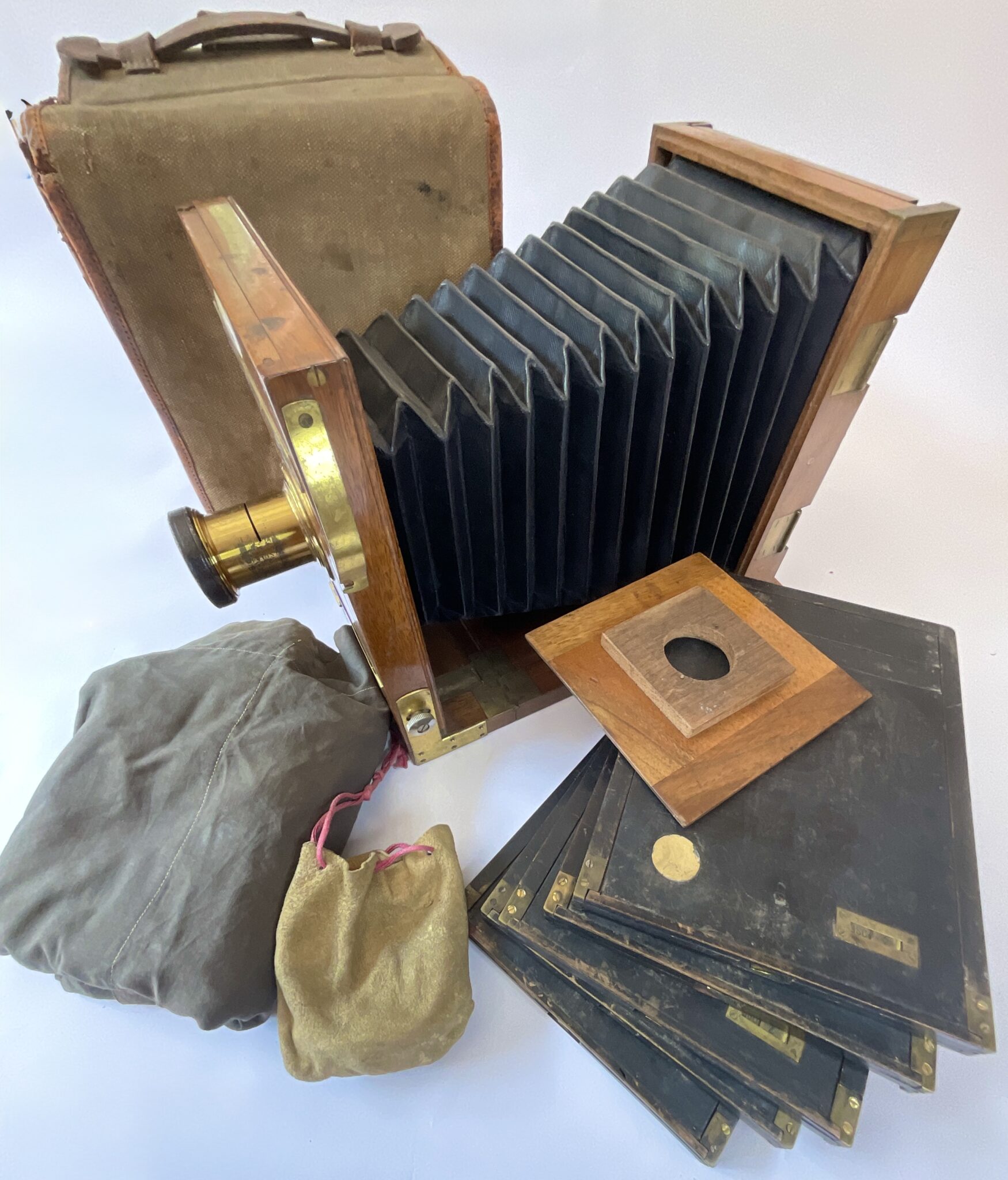 Camera circa 1880, French Tailboard camera with bag and accessories.