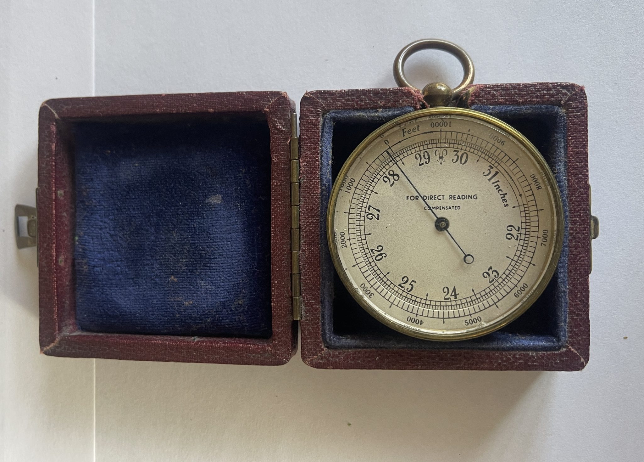 A CASED ANTIQUE BRASS CASED POCKET ALTIMETER.